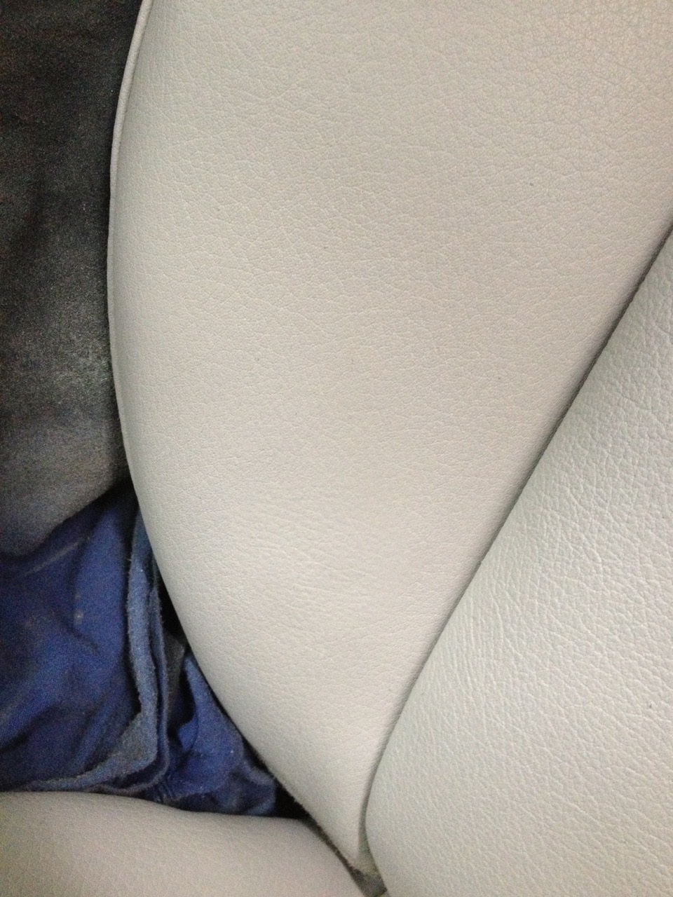 Restored light beige leather car seat upholstery.